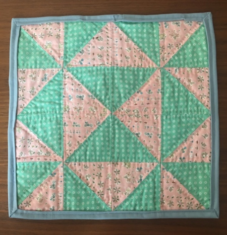 Half square triangle mini quilt with pink and mint green